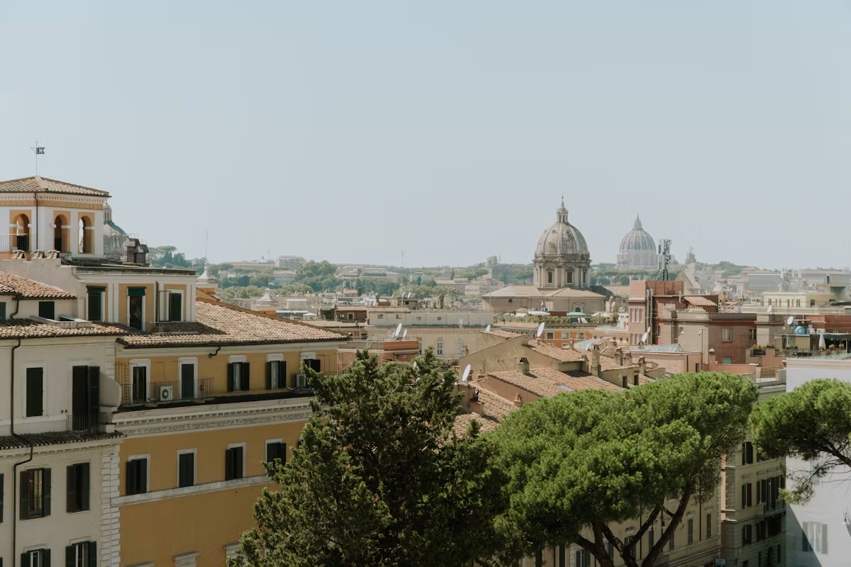 Church domes over Rome's rooftops, with St Peter's in the distance